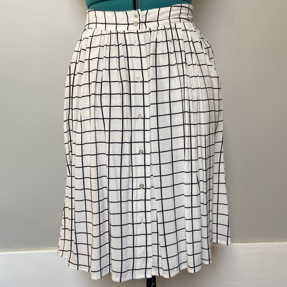 A-line midi-length button-front skirt in black and white grid pattern